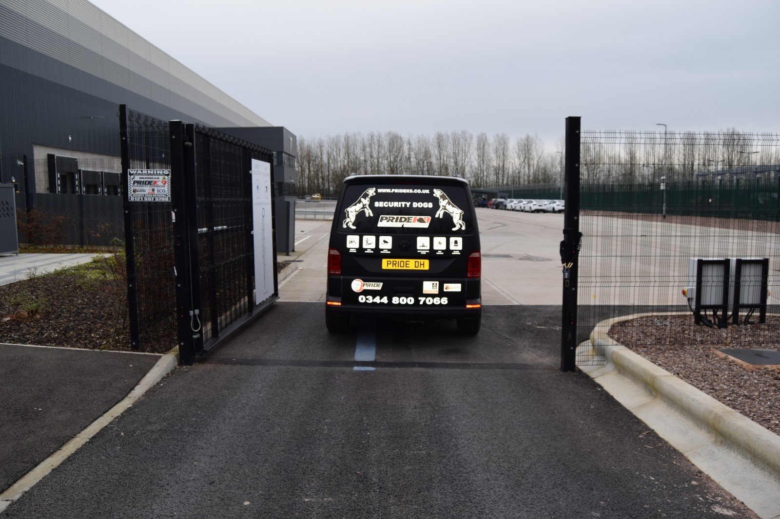 Security dog van entering a gated industrial facility