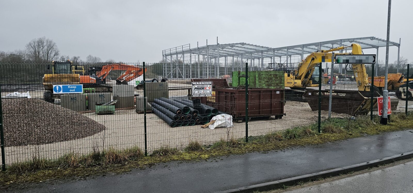 Construction site with steel framework and a Keep Out sign