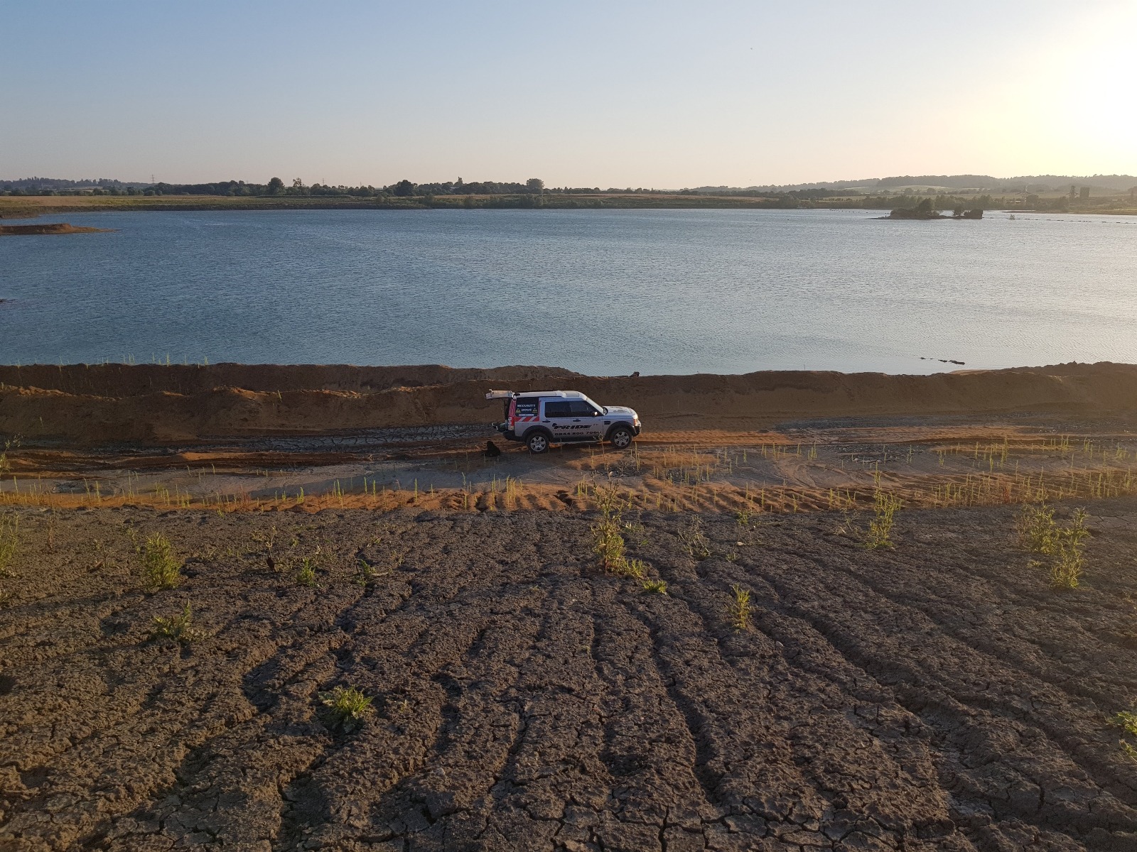 Off-road vehicle on rough ground near water